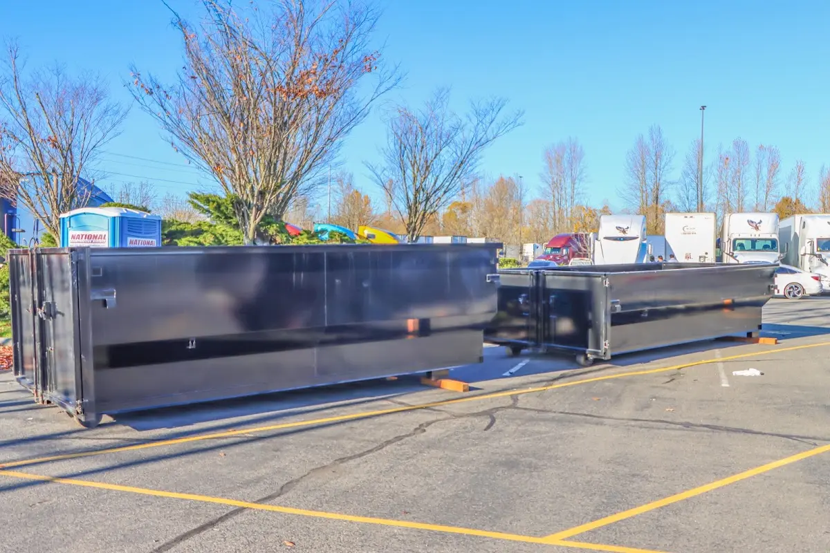 Professional dumpster rental service with roll-off container on residential driveway in Hooksett